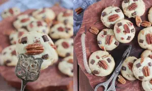 Leckere Pekannuss-Cookies mit Schokostückchen, einige auf einem Silberlöffel, andere auf einem Holzbrett mit einer kleinen Zange.