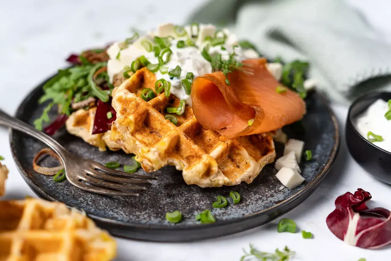 Herzhafte Waffeln mit Räucherlachs, Frischkäse und Schnittlauch. Ein köstliches Gericht, das Lust auf mehr macht.