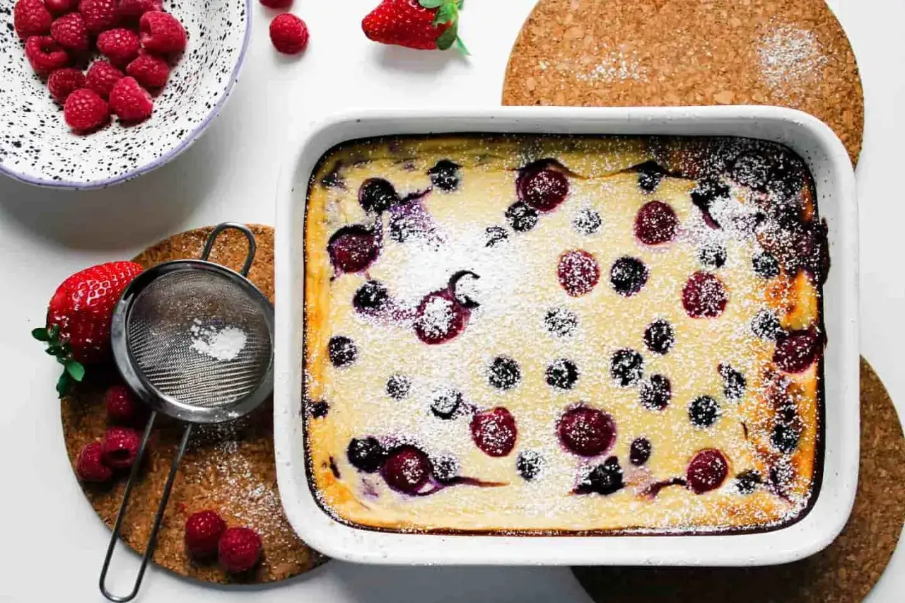 Frisch gebackener Beerenauflauf, ein Traum für alle Dessert-Rezepte-Liebhaber. Mit Puderzucker bestäubt und frischen Beeren garniert.